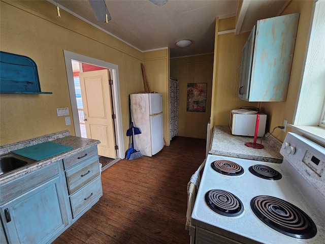833 Kahla Dr, Crystal Beach, TX 77650 - kitchen with white appliances, dark wood-style flooring, ornamental molding, and light countertops