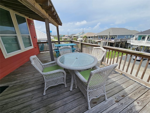 833 Kahla Dr, Crystal Beach, TX 77650 - wooden terrace featuring outdoor dining area and a residential view