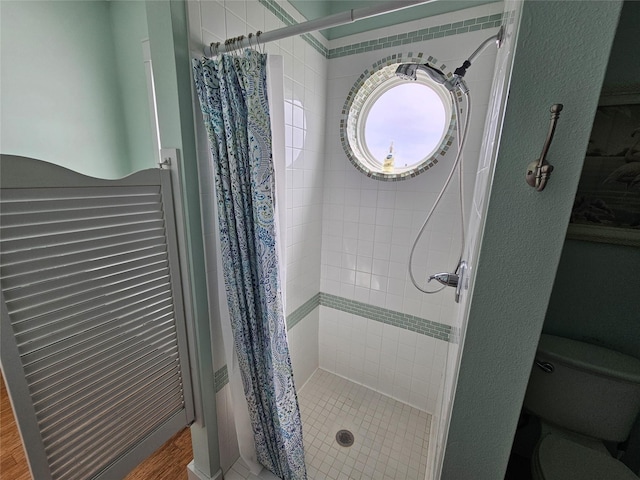 833 Kahla Dr, Crystal Beach, TX 77650 - bathroom featuring a shower stall, toilet, and wood finished floors