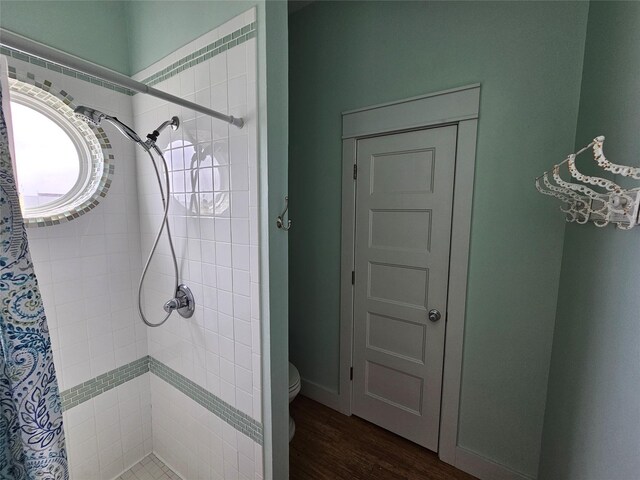 833 Kahla Dr, Crystal Beach, TX 77650 - bathroom with a shower stall, toilet, and wood finished floors