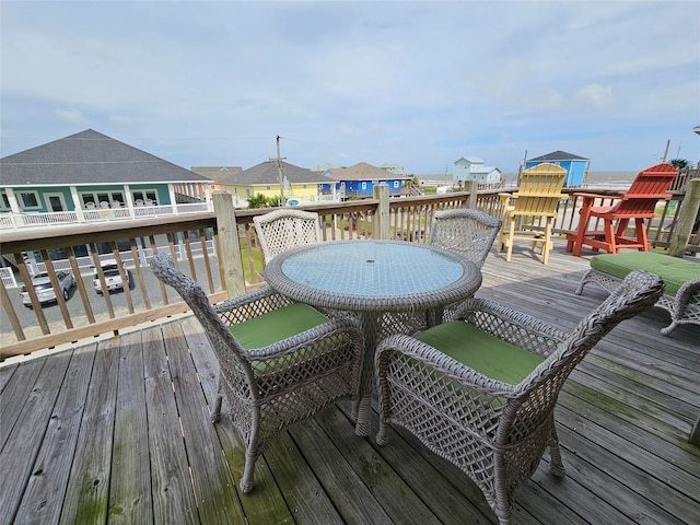 833 Kahla Dr, Crystal Beach, TX 77650 - wooden terrace with outdoor dining space and a residential view