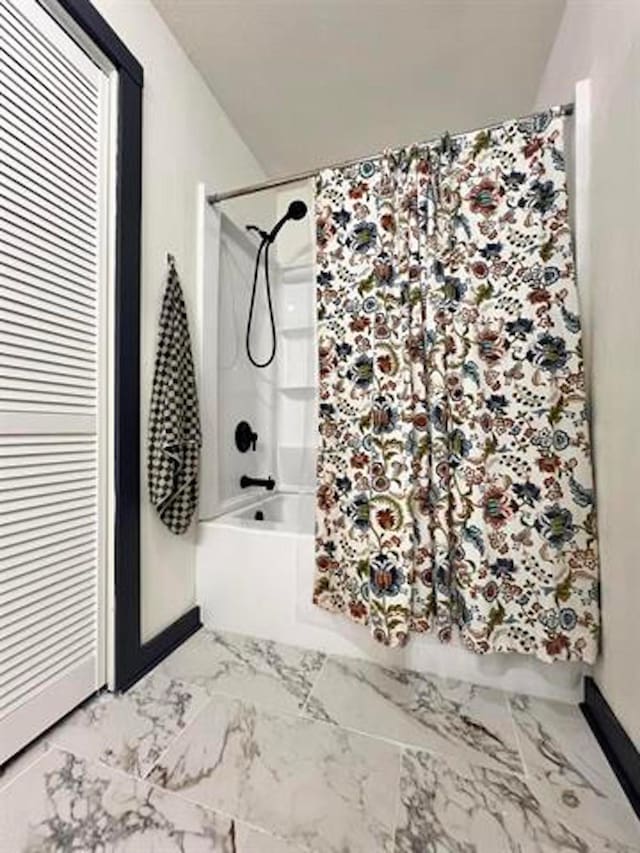 880 E Tram Rd, Vidor, TX 77662 - bathroom featuring shower / bath combo with shower curtain and marble finish flooring