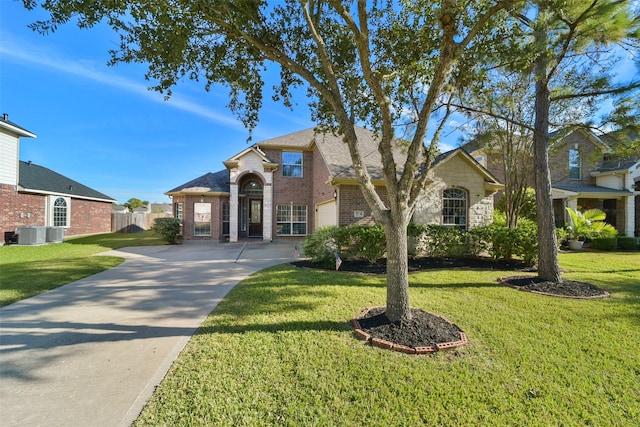 1214 Riverchase Dr, Richmond, TX 77469 - traditional-style house featuring driveway, brick siding, and central air condition unit