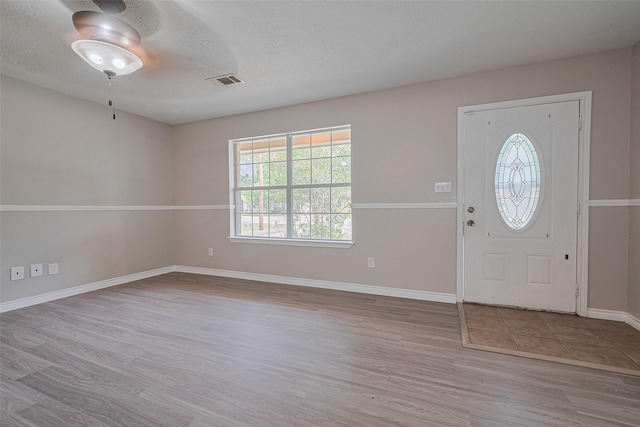 210 N Shirley Ln, Willis, TX 77378 - entryway with wood finished floors, baseboards, and a textured ceiling