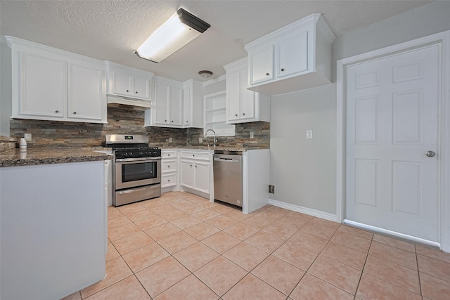 210 N Shirley Ln, Willis, TX 77378 - kitchen with appliances with stainless steel finishes, backsplash, a sink, white cabinets, and under cabinet range hood