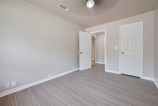 210 N Shirley Ln, Willis, TX 77378 - empty room featuring wood finished floors, baseboards, ceiling fan, and a textured ceiling