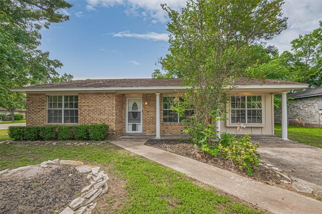 210 N Shirley Ln, Willis, TX 77378 - single story home with brick siding and a front lawn