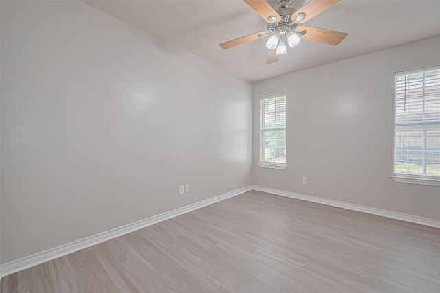 210 N Shirley Ln, Willis, TX 77378 - spare room featuring light wood-type flooring, baseboards, plenty of natural light, and ceiling fan