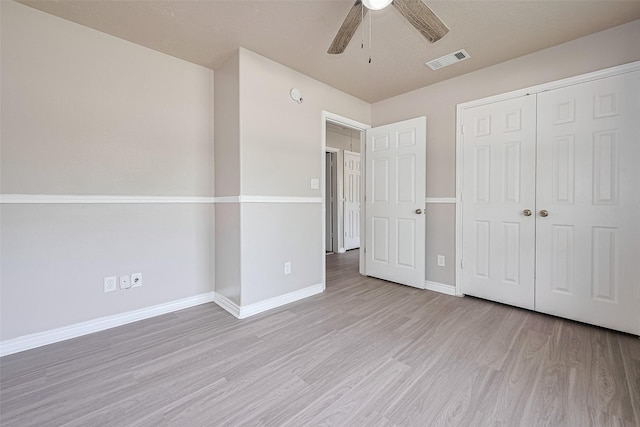 210 N Shirley Ln, Willis, TX 77378 - unfurnished bedroom featuring light wood-style floors, baseboards, a closet, and a ceiling fan