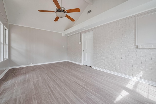 210 N Shirley Ln, Willis, TX 77378 - unfurnished room with beam ceiling, a ceiling fan, wood finished floors, brick wall, and baseboards