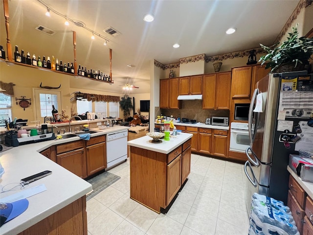 12931 Blackbrook Ln, Houston, TX 77041 - kitchen with a sink, stainless steel appliances, brown cabinets, a kitchen island, and recessed lighting