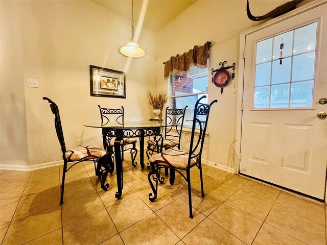 12931 Blackbrook Ln, Houston, TX 77041 - dining area featuring light tile patterned floors, plenty of natural light, baseboards, and lofted ceiling