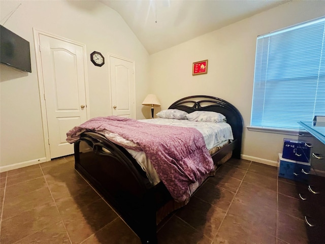 12931 Blackbrook Ln, Houston, TX 77041 - bedroom with tile patterned flooring, vaulted ceiling, and baseboards