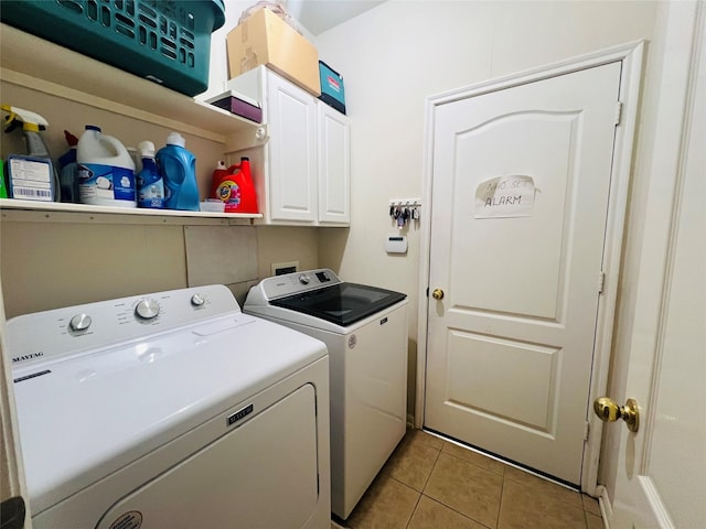 12931 Blackbrook Ln, Houston, TX 77041 - laundry area with washer and clothes dryer, cabinet space, and light tile patterned floors