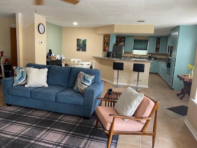21626 Gentry Rd, Cypress, TX 77429 - living room featuring light tile patterned floors, a ceiling fan, and recessed lighting