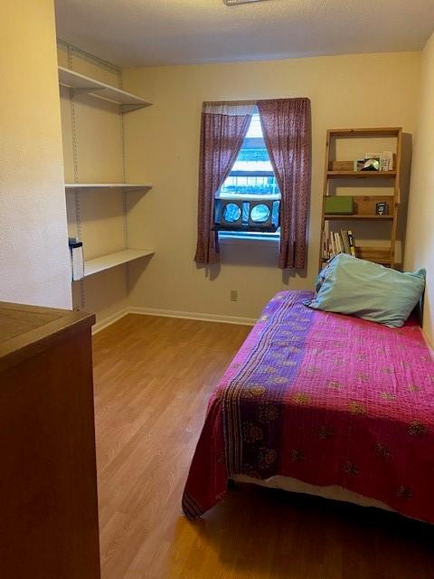21626 Gentry Rd, Cypress, TX 77429 - bedroom with wood finished floors and baseboards