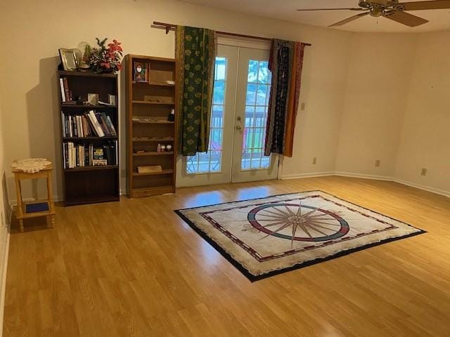 21626 Gentry Rd, Cypress, TX 77429 - doorway featuring wood finished floors, french doors, a ceiling fan, and baseboards