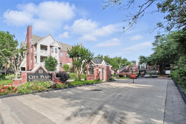 1330 Old Spanish Trl Unit 7207, Houston, TX 77054 - view of asphalt road with a residential view, curbs, traffic signs, and a gated entry
