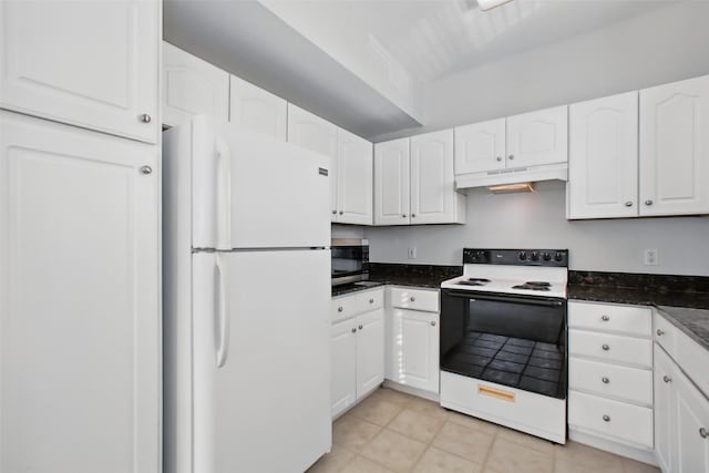 1330 Old Spanish Trl Unit 7207, Houston, TX 77054 - kitchen with freestanding refrigerator, electric stove, under cabinet range hood, stainless steel microwave, and white cabinets