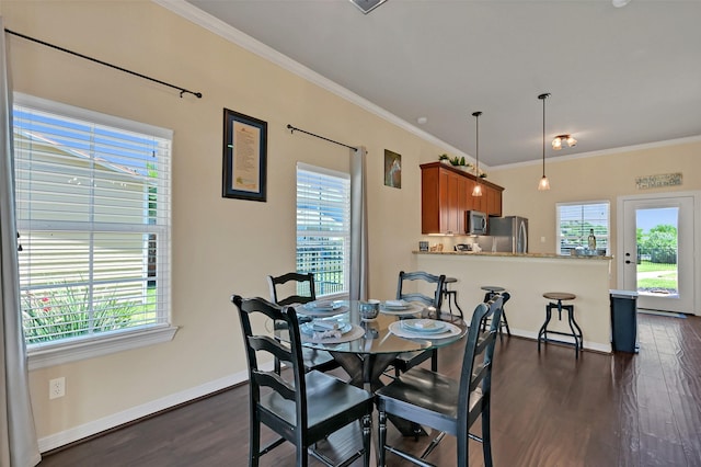 607 29th St, Dickinson, TX 77539 - dining space with plenty of natural light, dark wood-style floors, crown molding, and baseboards