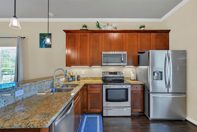 607 29th St, Dickinson, TX 77539 - kitchen featuring appliances with stainless steel finishes, a sink, dark wood-style floors, a peninsula, and light stone counters