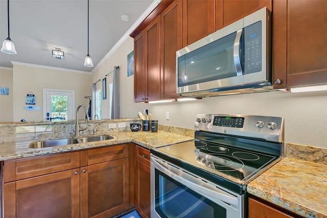 607 29th St, Dickinson, TX 77539 - kitchen with appliances with stainless steel finishes, a sink, ornamental molding, light stone countertops, and pendant lighting