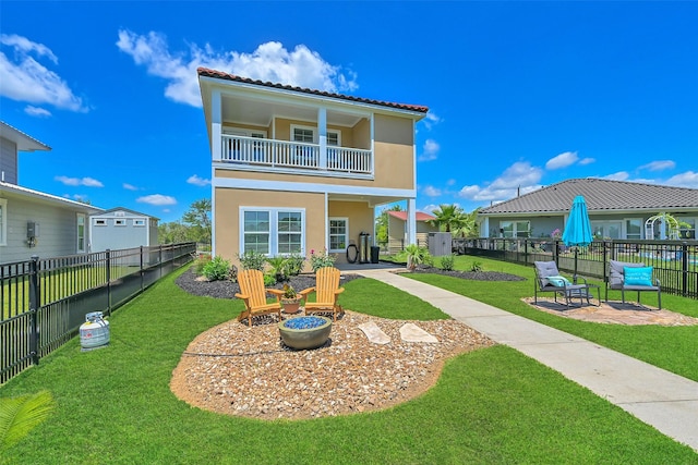 607 29th St, Dickinson, TX 77539 - back of property featuring a balcony, stucco siding, a patio, and a tile roof