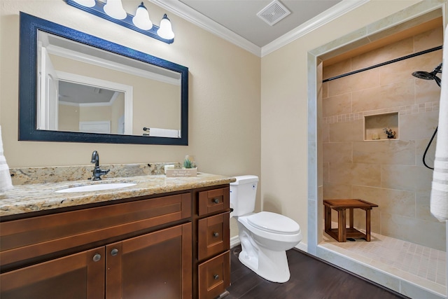 607 29th St, Dickinson, TX 77539 - full bath with wood finished floors, toilet, crown molding, vanity, and a tile shower