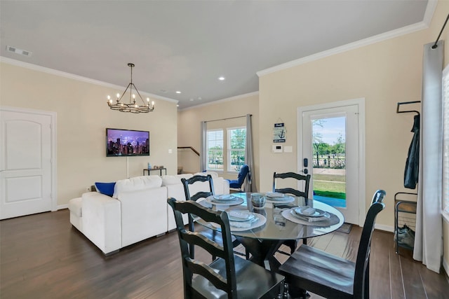 607 29th St, Dickinson, TX 77539 - dining room with dark wood finished floors, ornamental molding, a chandelier, baseboards, and recessed lighting