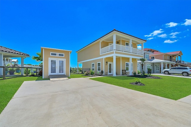 607 29th St, Dickinson, TX 77539 - view of front of house with french doors, a balcony, stucco siding, and a tile roof