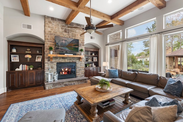27433 S Lazy Meadow Way, Spring, TX 77386 - living area with a stone fireplace, wood finished floors, beam ceiling, ceiling fan, and recessed lighting