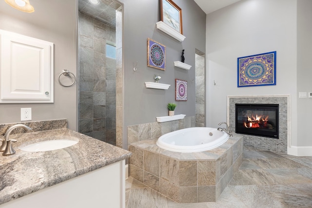 27433 S Lazy Meadow Way, Spring, TX 77386 - bathroom featuring a tile fireplace, a garden tub, vanity, and a tile shower