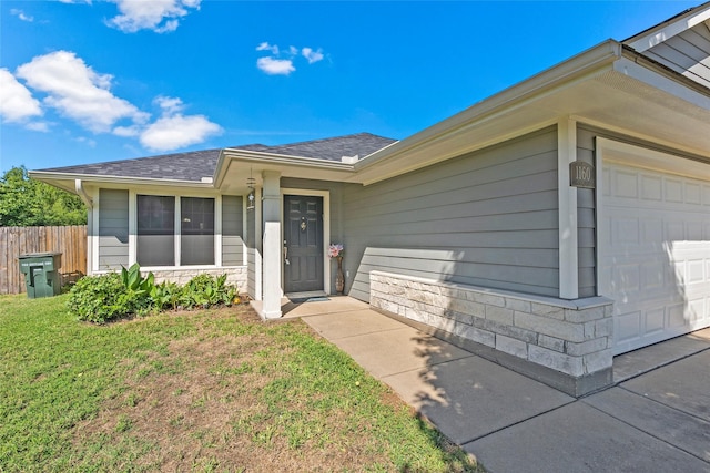 1160 Cottage Grove Cir, Bryan, TX 77801 - property entrance with stone siding, roof with shingles, and an attached garage