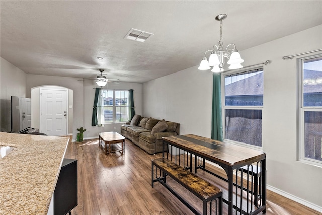 1160 Cottage Grove Cir, Bryan, TX 77801 - dining area featuring wood finished floors, baseboards, a ceiling fan, a chandelier, and arched walkways