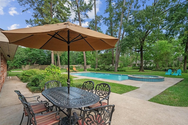 1710 Magnolia Ln, Kingwood, TX 77339 - view of pool featuring a patio area, a yard, outdoor dining area, and view of wooded area