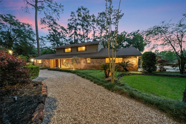 1710 Magnolia Ln, Kingwood, TX 77339 - view of front of home featuring driveway, a front yard, and brick siding