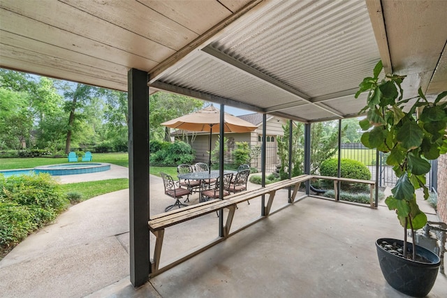 1710 Magnolia Ln, Kingwood, TX 77339 - view of patio / terrace with a jacuzzi, outdoor dining space, and an outdoor pool