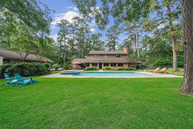 1710 Magnolia Ln, Kingwood, TX 77339 - rear view of property with a chimney, a yard, a patio area, and a pool with connected hot tub