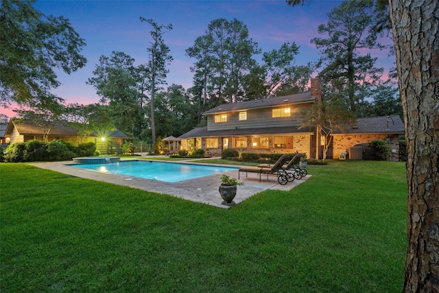 1710 Magnolia Ln, Kingwood, TX 77339 - outdoor pool with a patio area, a lawn, and central air condition unit