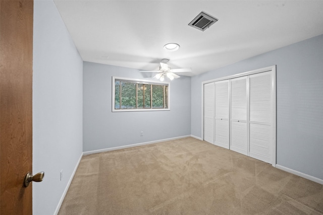 1710 Magnolia Ln, Kingwood, TX 77339 - unfurnished bedroom with carpet floors, a closet, baseboards, and a ceiling fan
