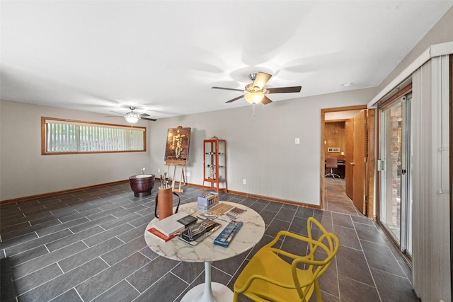 1710 Magnolia Ln, Kingwood, TX 77339 - living room with ceiling fan, baseboards, and dark tile patterned floors