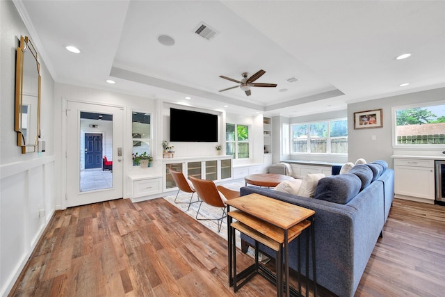 1345 Curtin St, Houston, TX 77018 - living area with a raised ceiling, crown molding, light wood-type flooring, plenty of natural light, and recessed lighting
