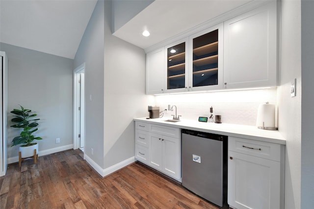1345 Curtin St, Houston, TX 77018 - indoor wet bar featuring refrigerator, decorative backsplash, dark wood-type flooring, baseboards, and lofted ceiling