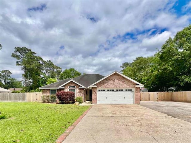 225 Lexington Dr, Vidor, TX 77662 - ranch-style home with a garage, driveway, and brick siding