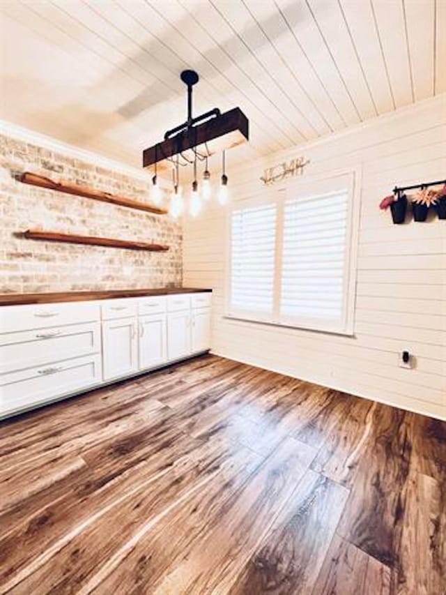 225 Lexington Dr, Vidor, TX 77662 - interior space with wooden ceiling, wood finished floors, and brick wall