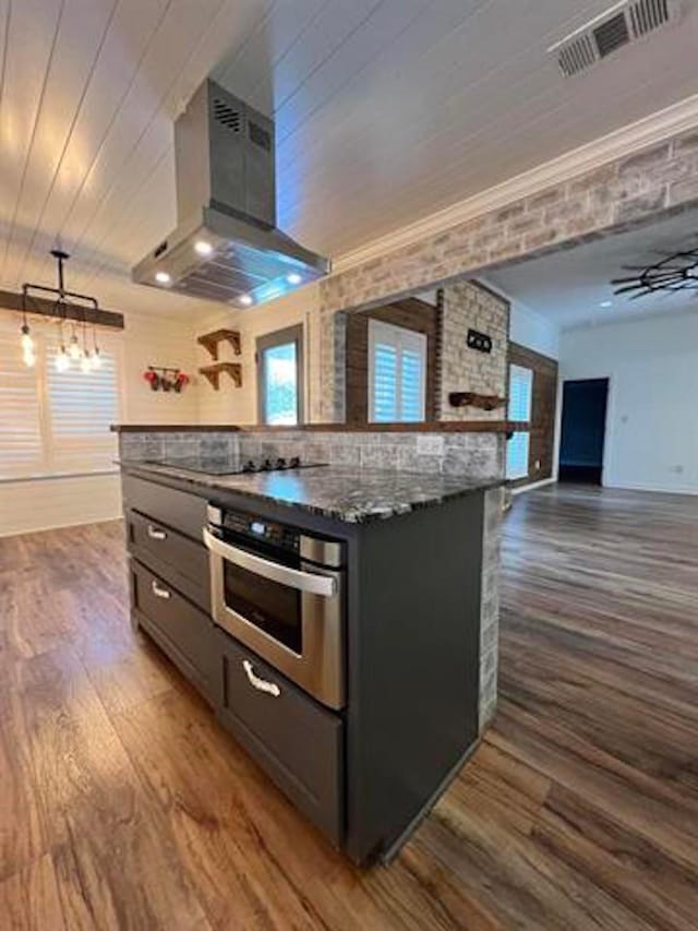 225 Lexington Dr, Vidor, TX 77662 - kitchen featuring stainless steel oven, wall chimney range hood, black electric stovetop, dark wood finished floors, and wood ceiling