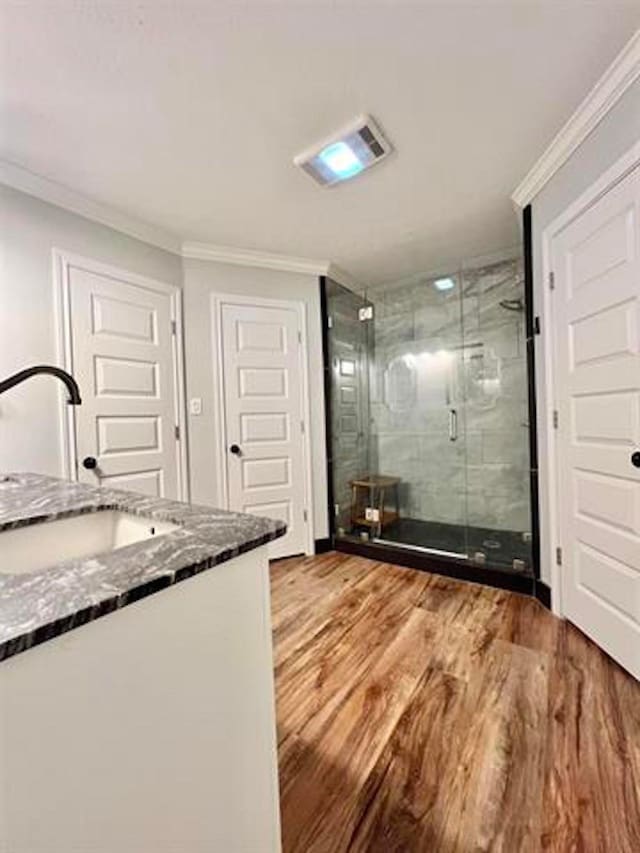 225 Lexington Dr, Vidor, TX 77662 - full bathroom featuring crown molding, vanity, wood finished floors, and a shower stall