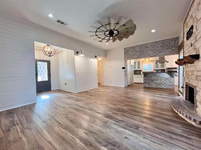 225 Lexington Dr, Vidor, TX 77662 - unfurnished living room with a chandelier, a large fireplace, wood finished floors, recessed lighting, and baseboards