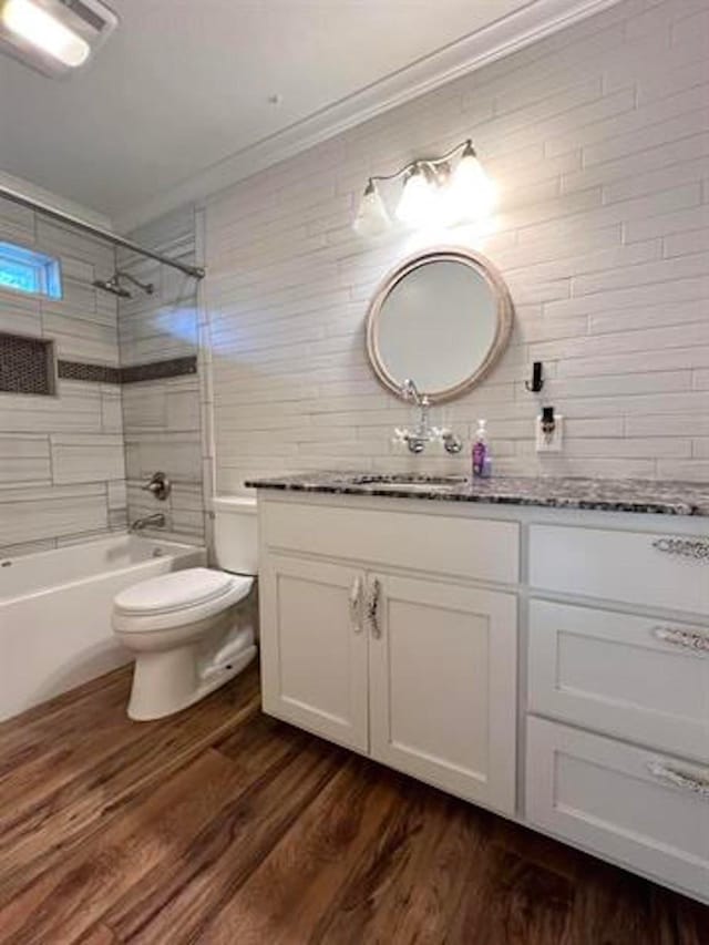 225 Lexington Dr, Vidor, TX 77662 - full bath with vanity, wood finished floors, toilet,  shower combination, and ornamental molding