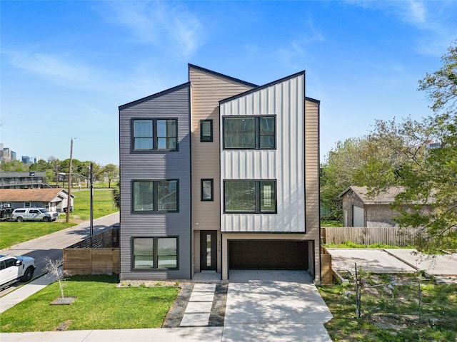 3475 Simmons St, Houston, TX 77004 - view of front of property with board and batten siding, an attached garage, and concrete driveway